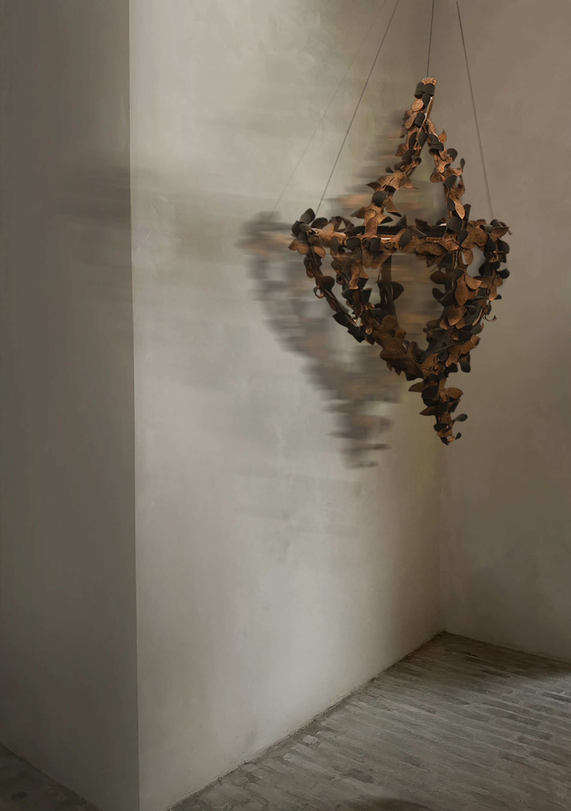 Mobile object 'Payonk' hanging in an indoor corner, captured with a motion blur effect to suggest movement.