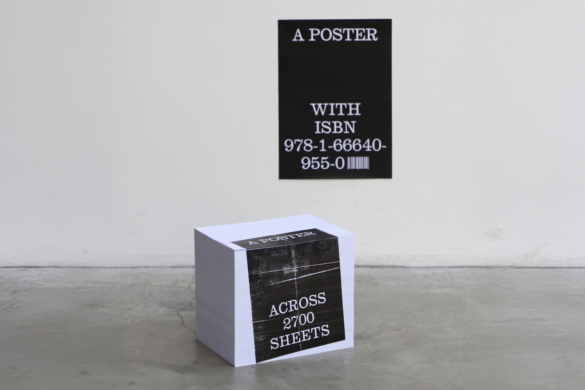 Two posters are shown as sculptural objects: one printed across the edges of 2,700 stacked sheets, the other on a single sheet with an ISBN, questioni