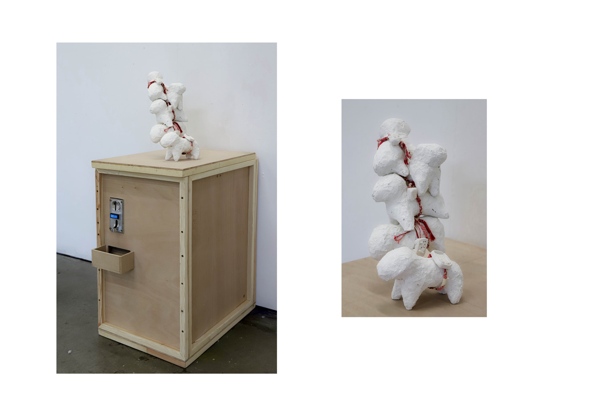 A coin-operated wooden box installation with a vertical stack of white sheep sculptures on top. The sheep are bound together with red braided thread.