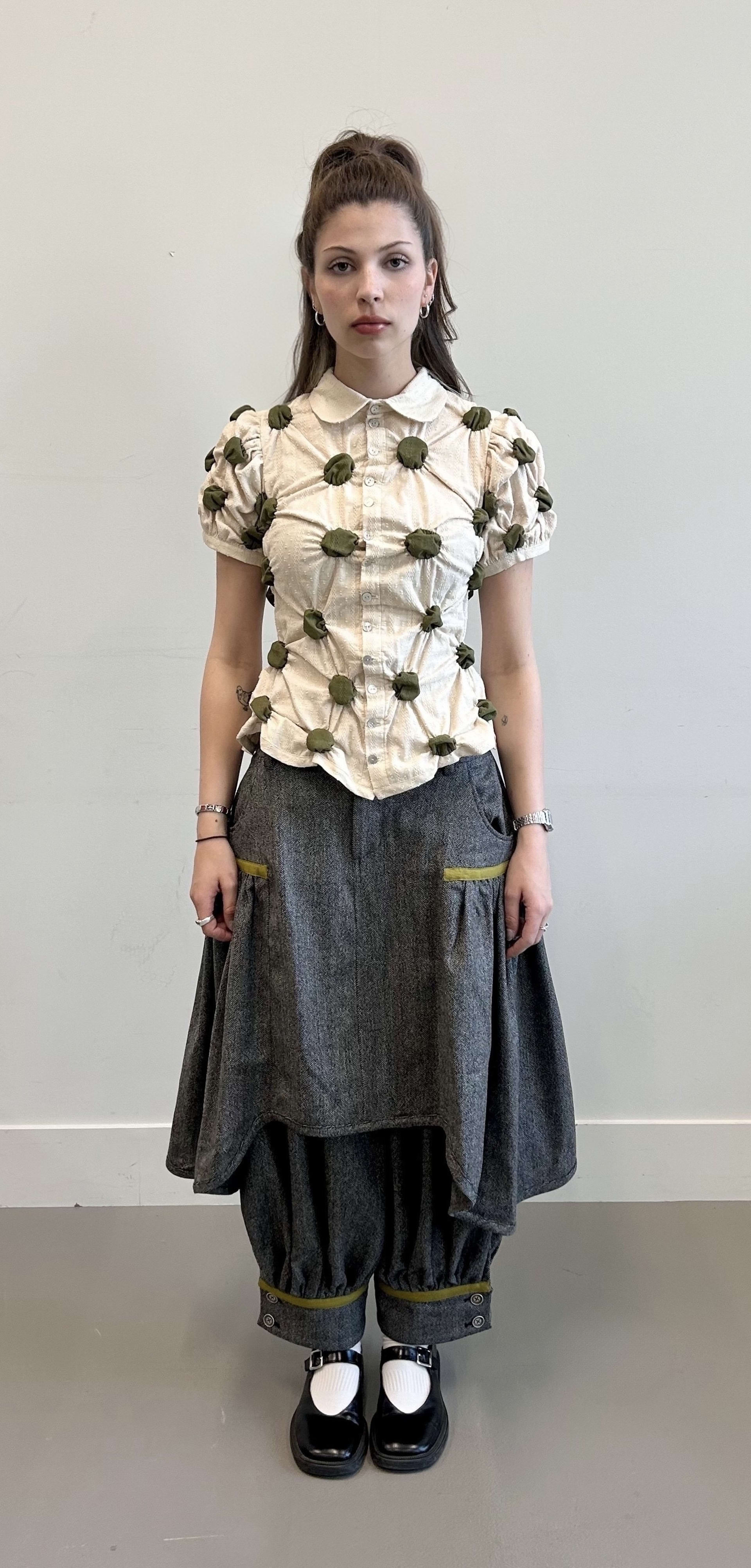 This image shows a polka-dot printed shirt and a herringbone wool trouser and skirt set