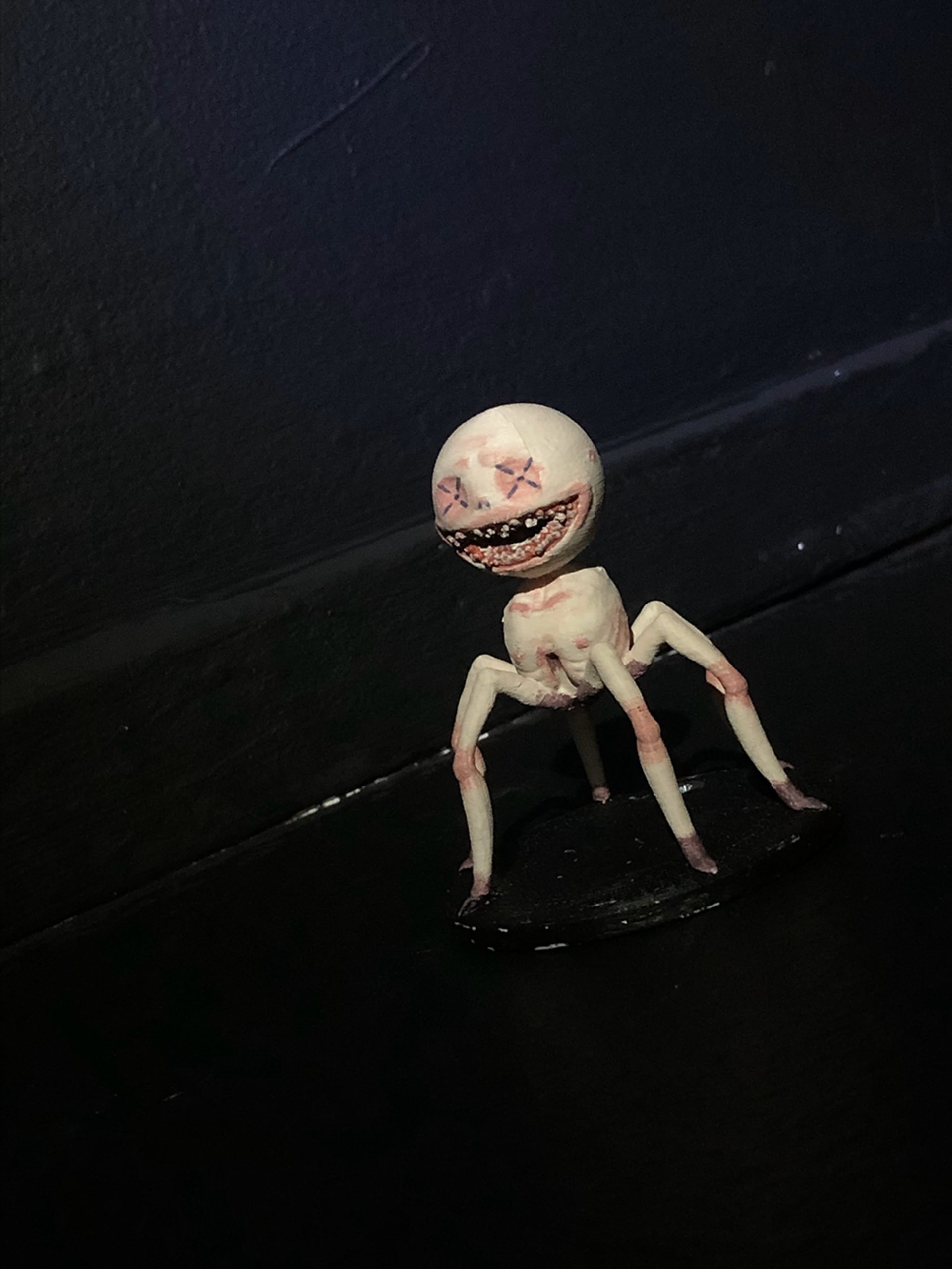 small six legged creature sculpture attached to a wall