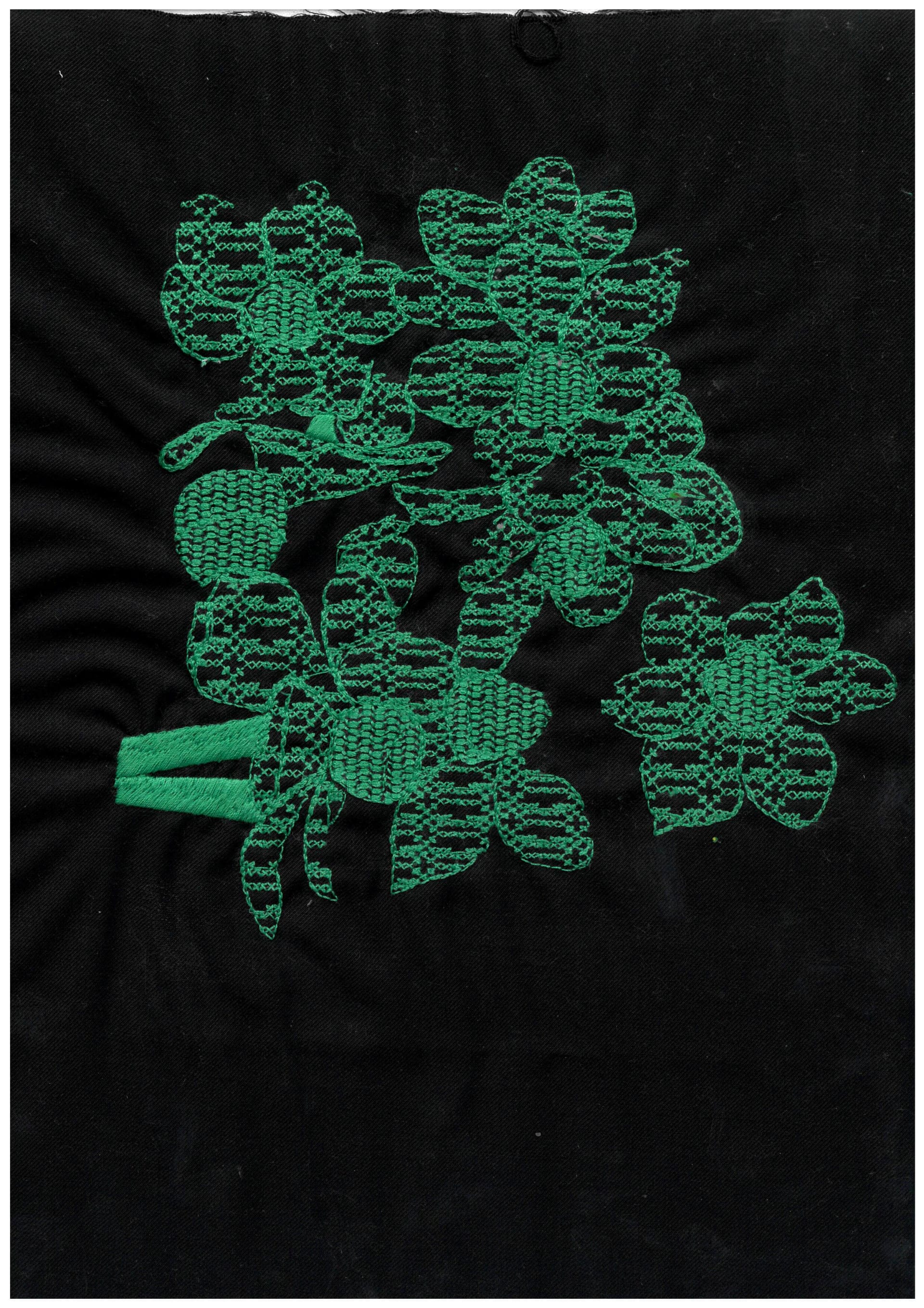 floral motif digitally embroidered in green cotton thread onto black fabric