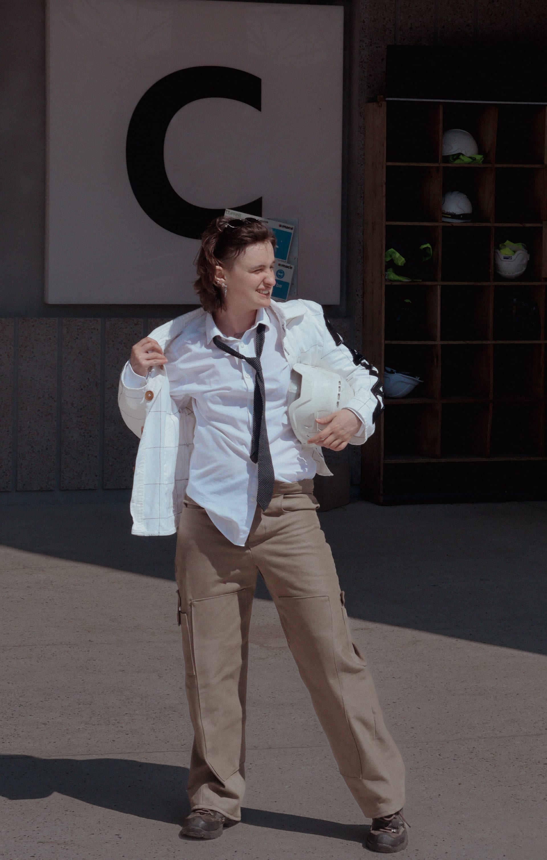 Checkered white chore jacket with NADAV patches with tailor trousers with functional scissor and sketchbook pockets