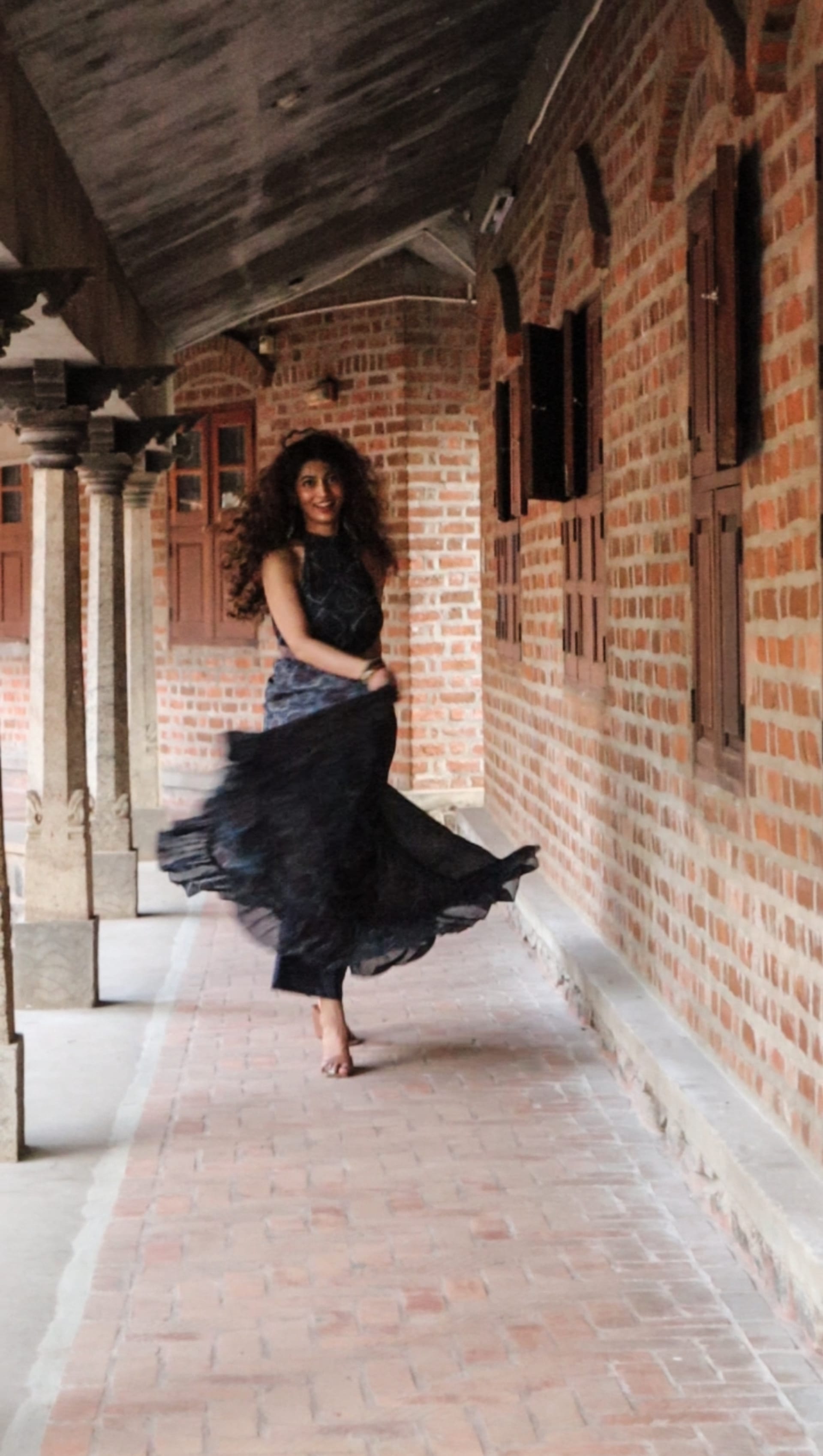 Woman twirling in a corridor