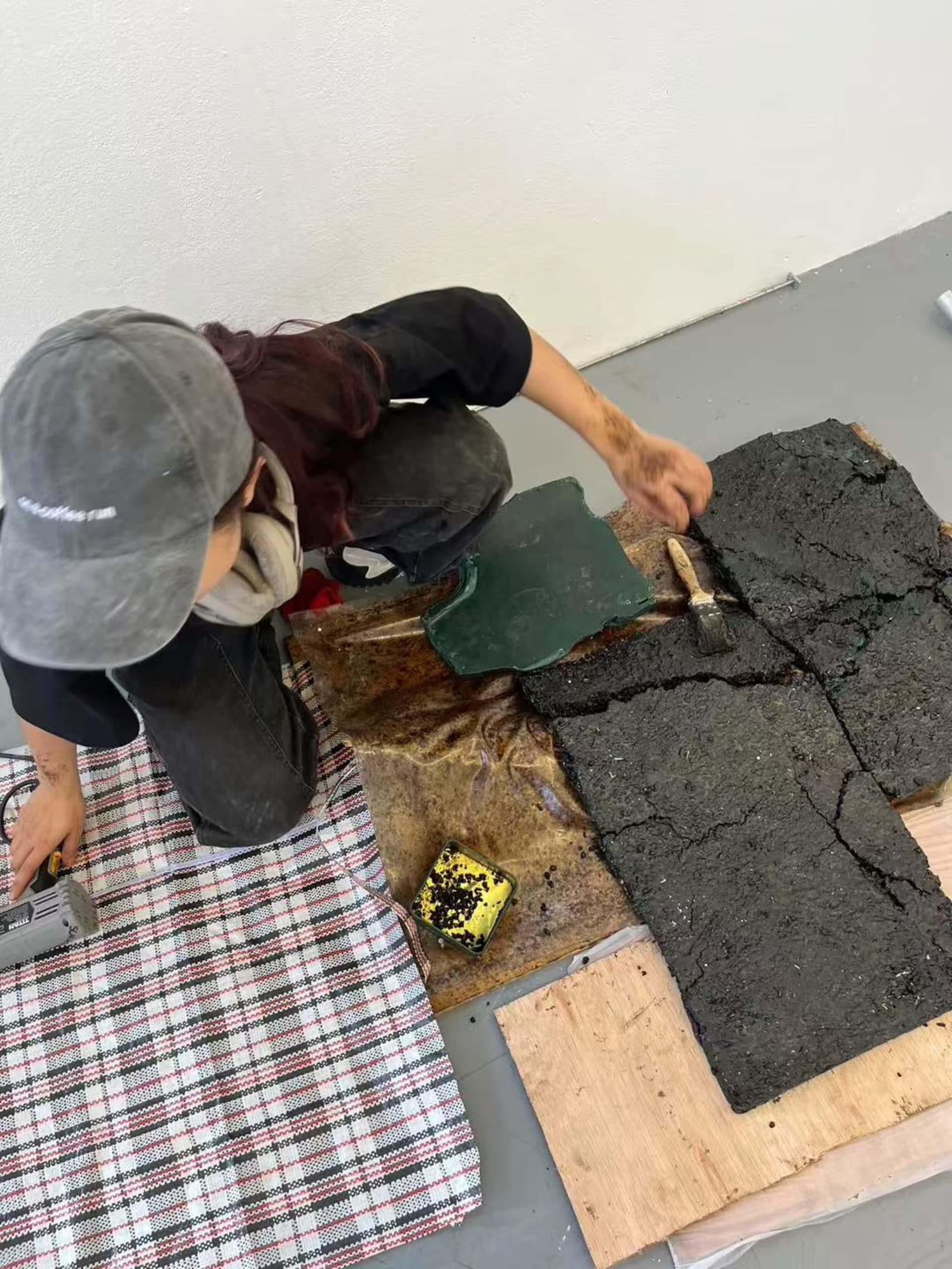 process of tarmac tiles; applying melted wax on tarmac