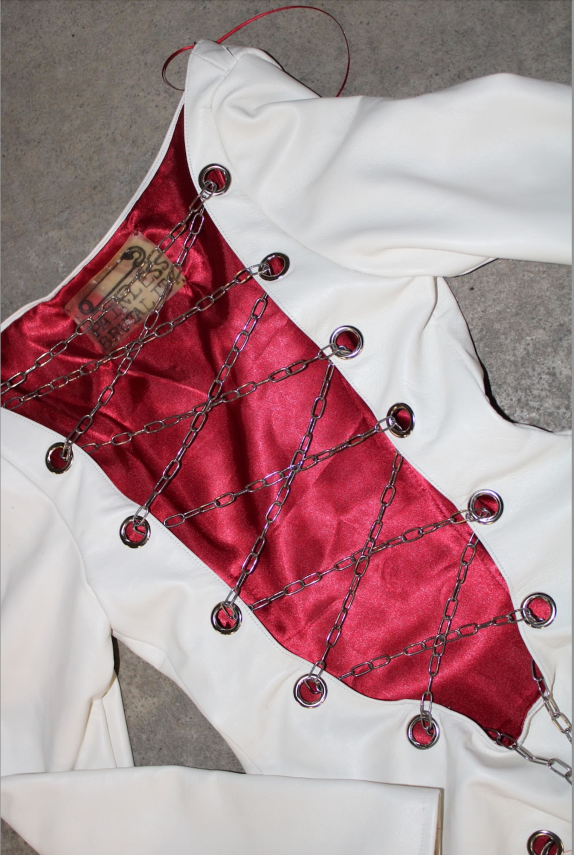 white leather dress with cut out and chain details