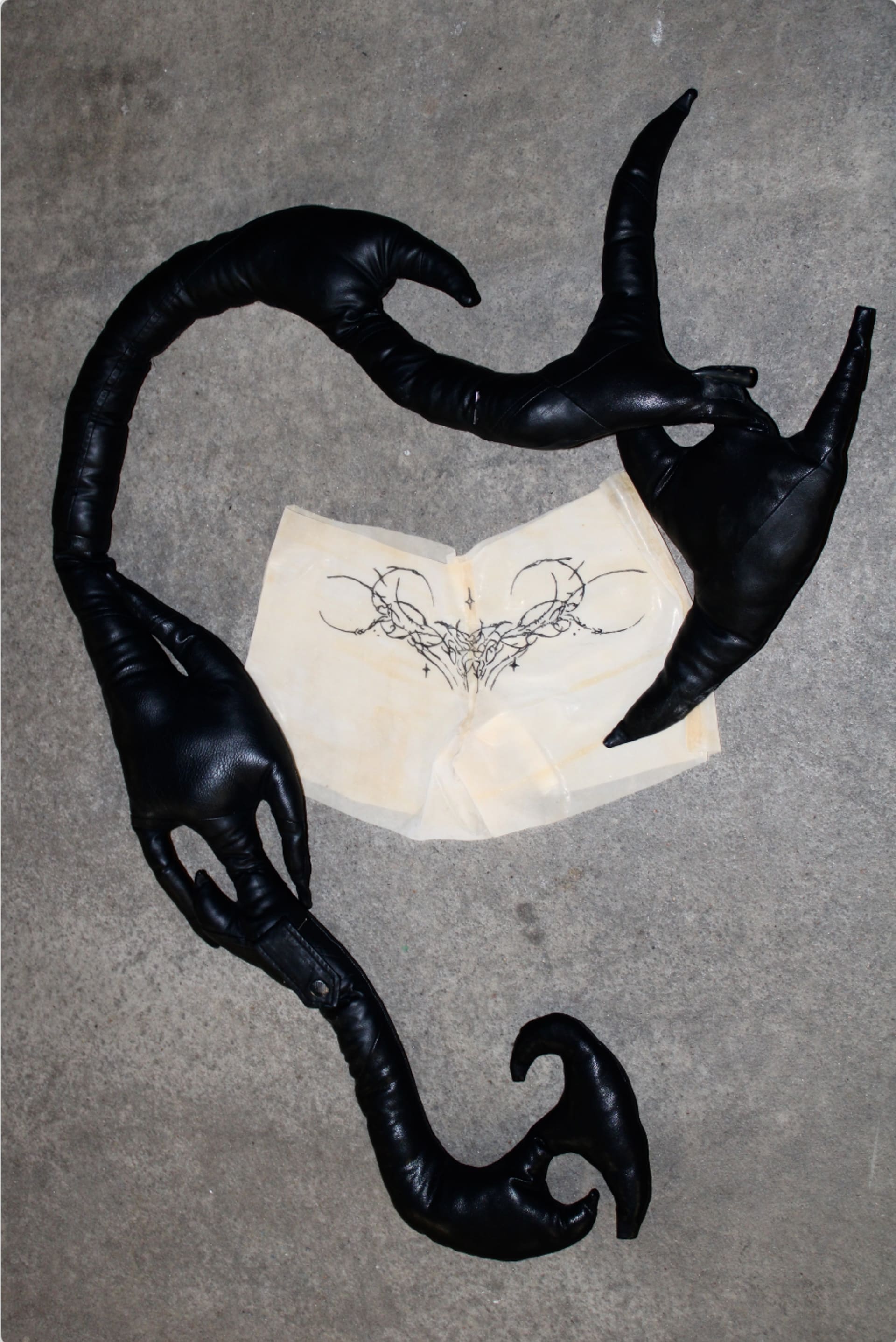 Latex mini shorts with a tattooed feature on the lower back