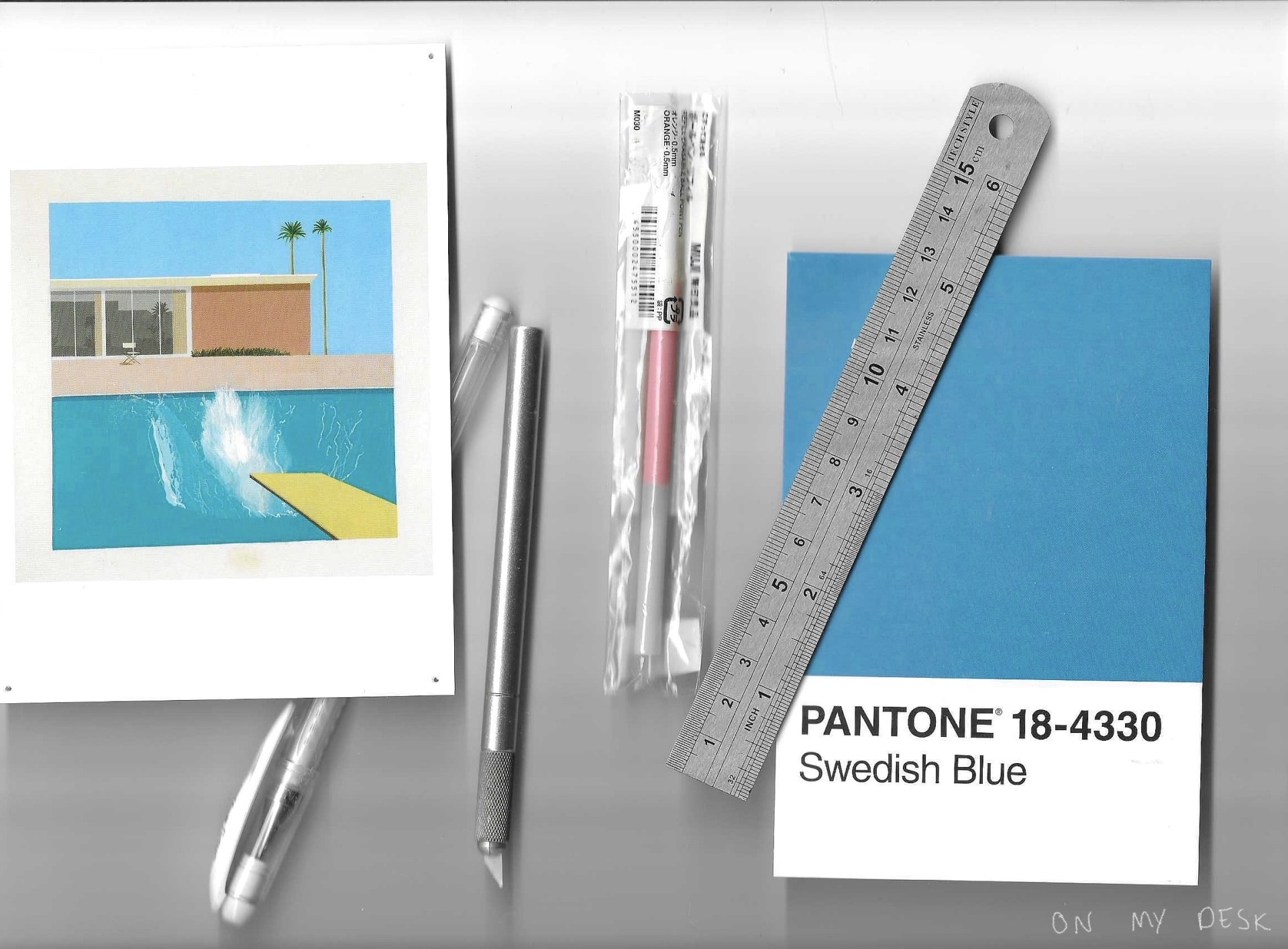 Various items from my desk - including pens, a knife for my collages and two pictures with my favourite colour: blue