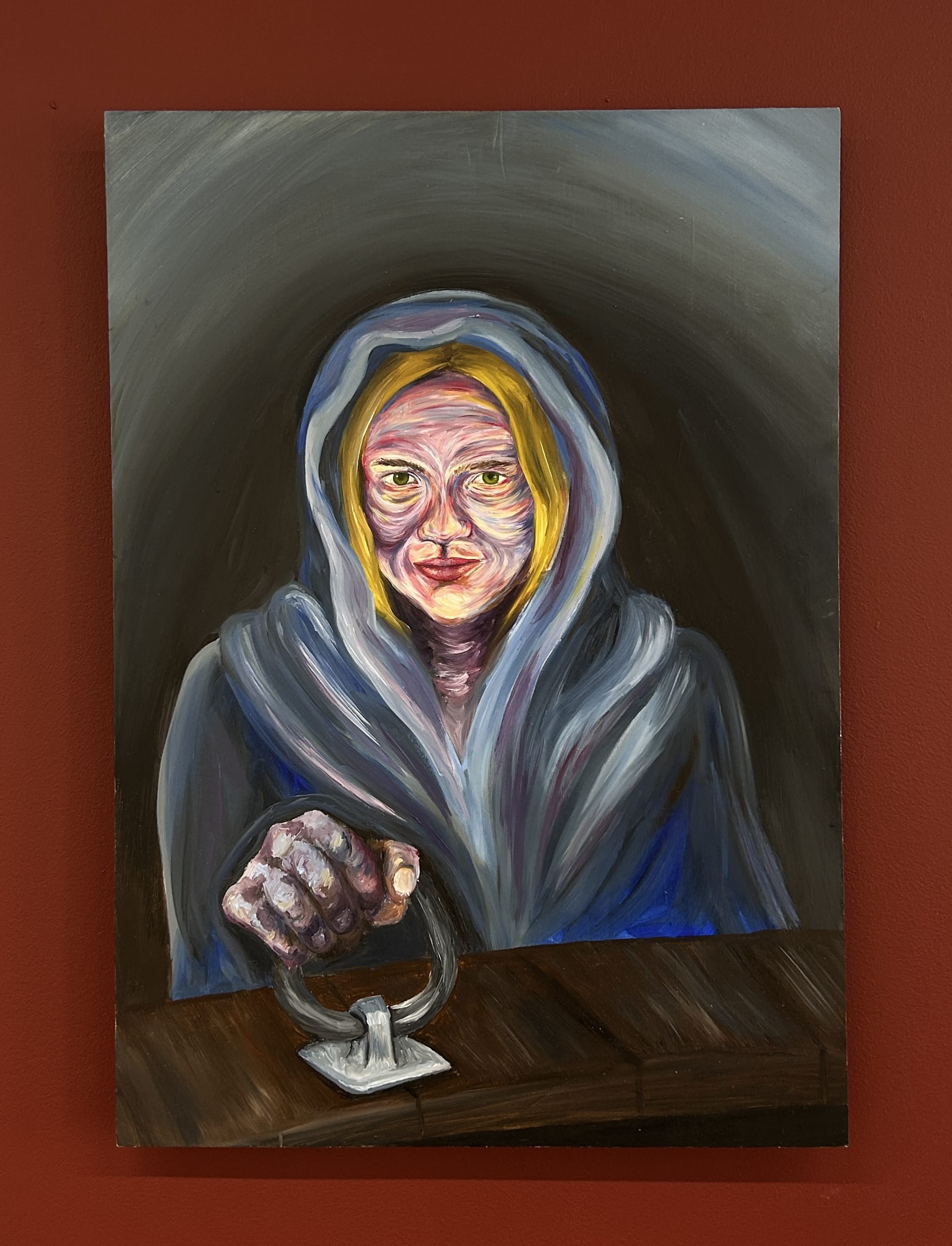 a woman is knelt on the floor cloaked and lit by moonlight ready to open the trapdoor