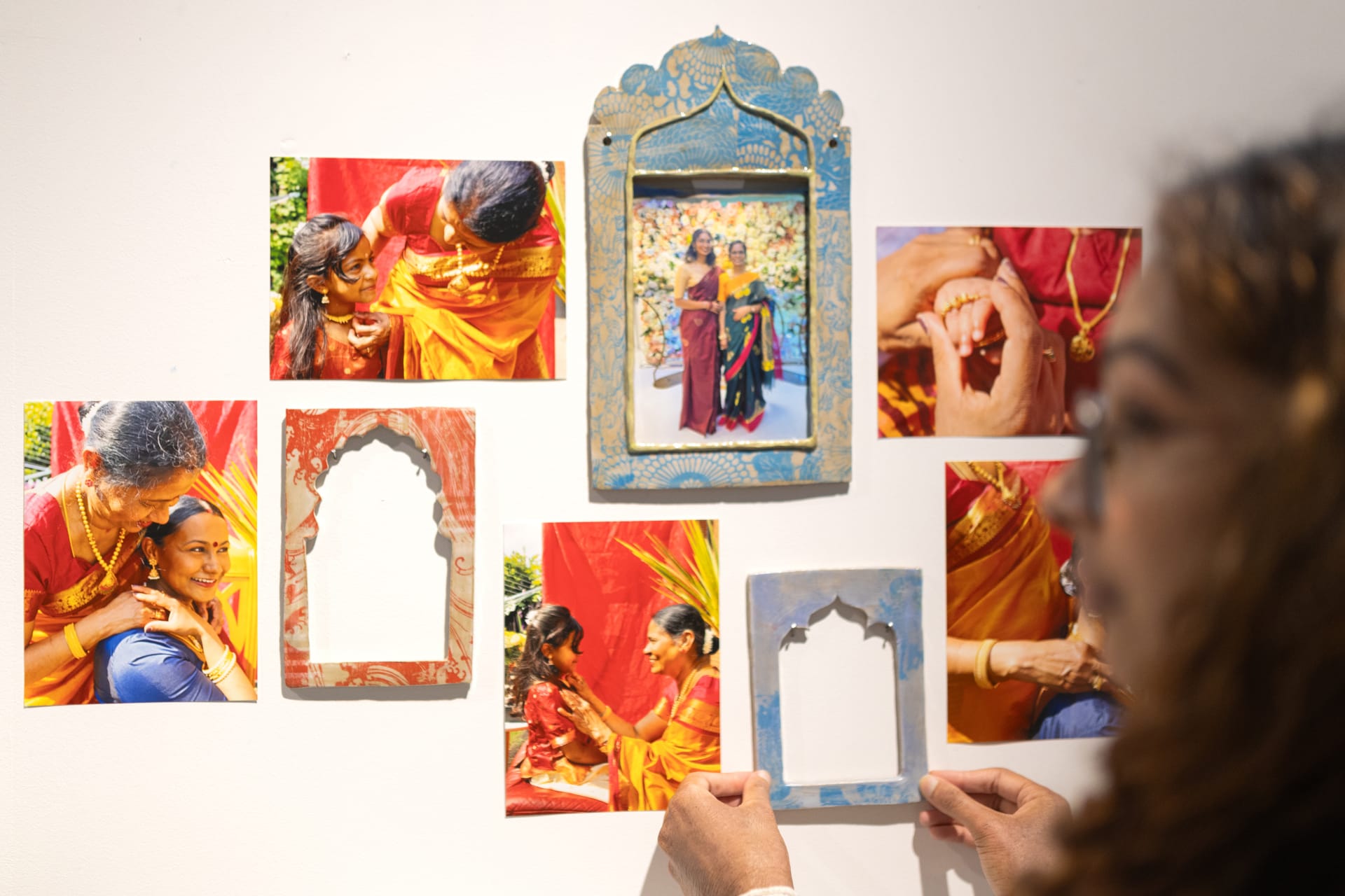 The photos being displayed on the wall with ceramic frames