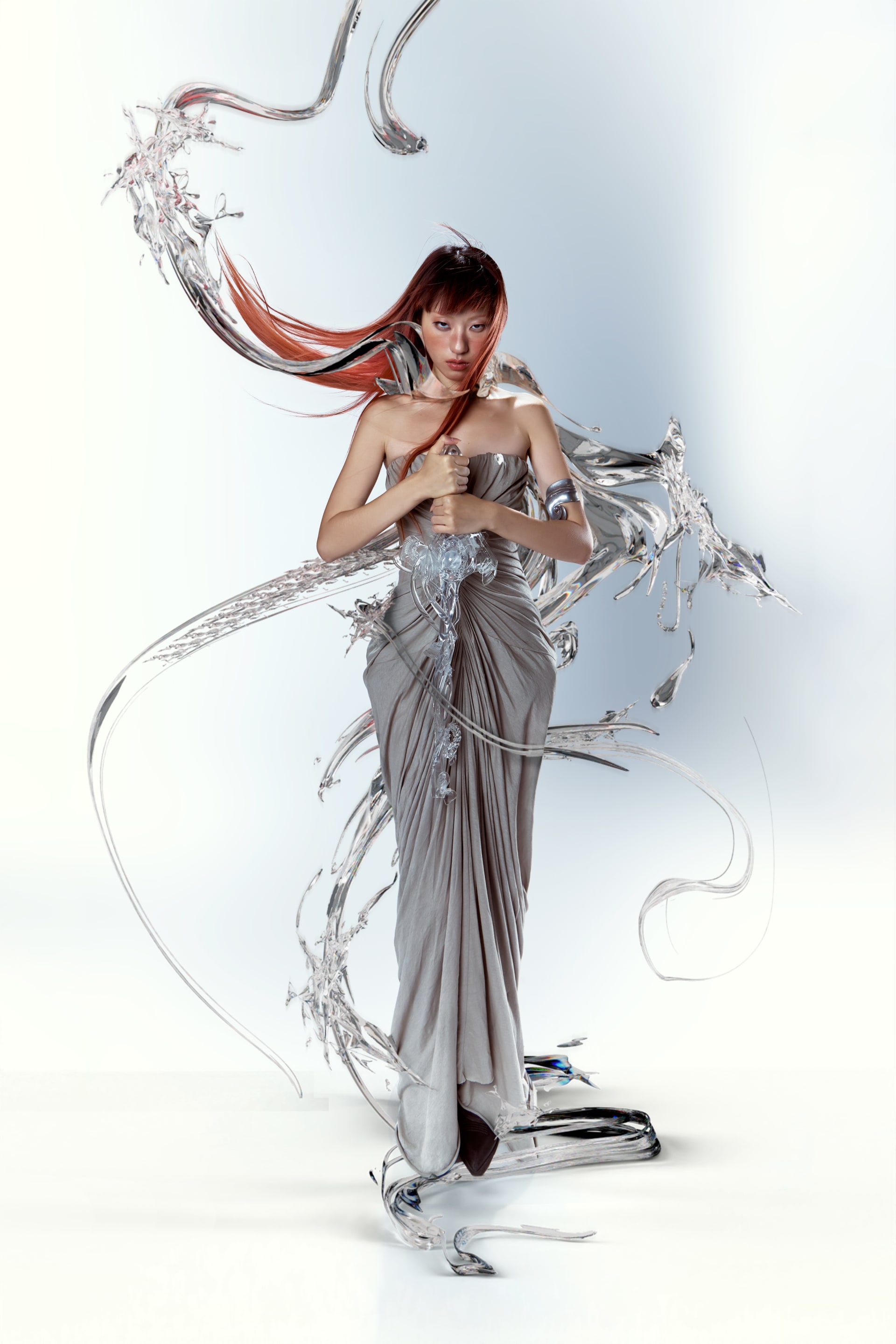 A woman in a flowing silver-grey gown holds a crystal-like sword, surrounded by liquid metal shapes.
