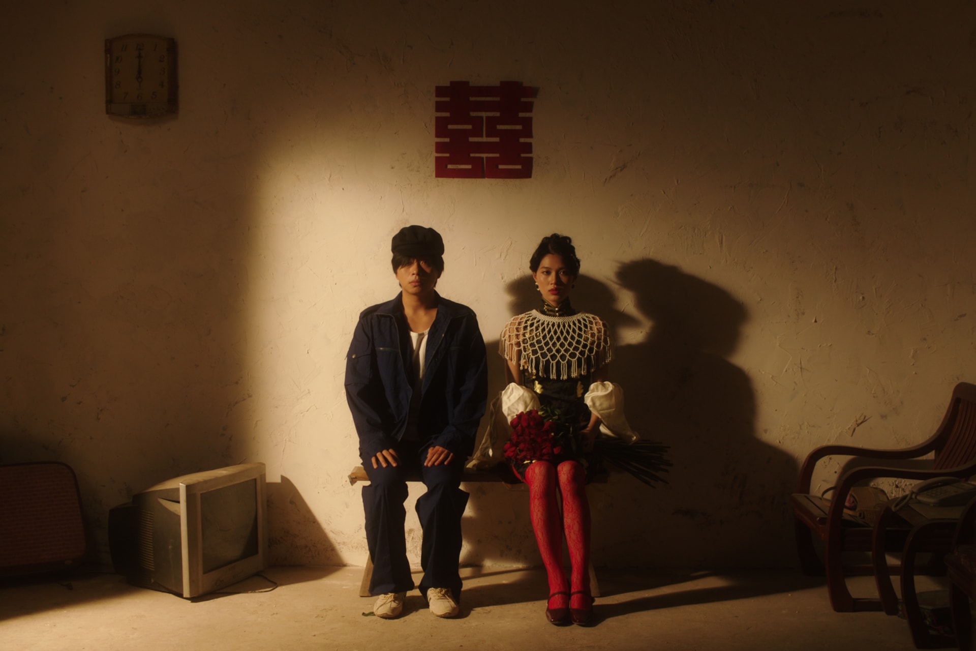 A male and female sitting in a wedding room.