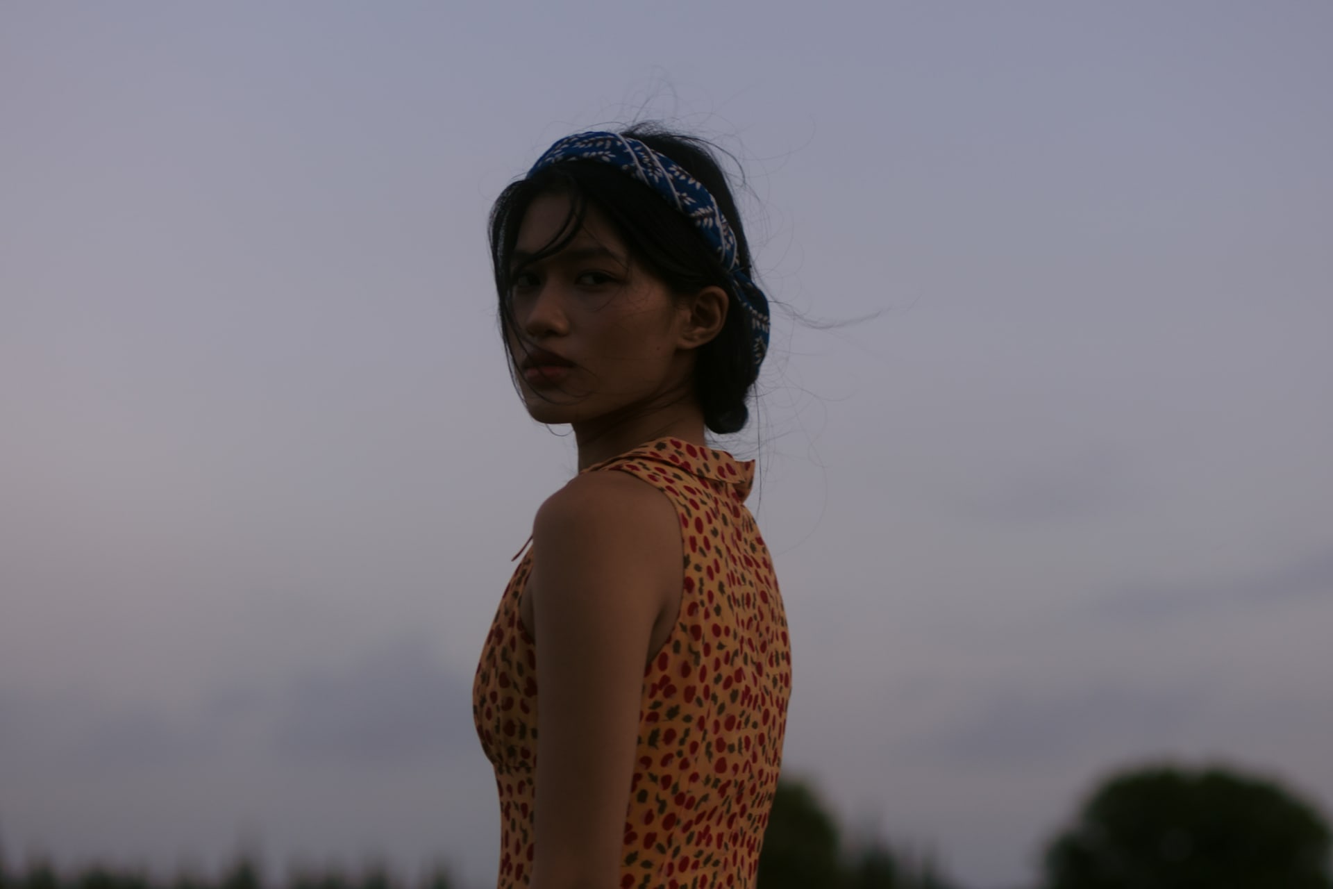 A female standing in the wind.