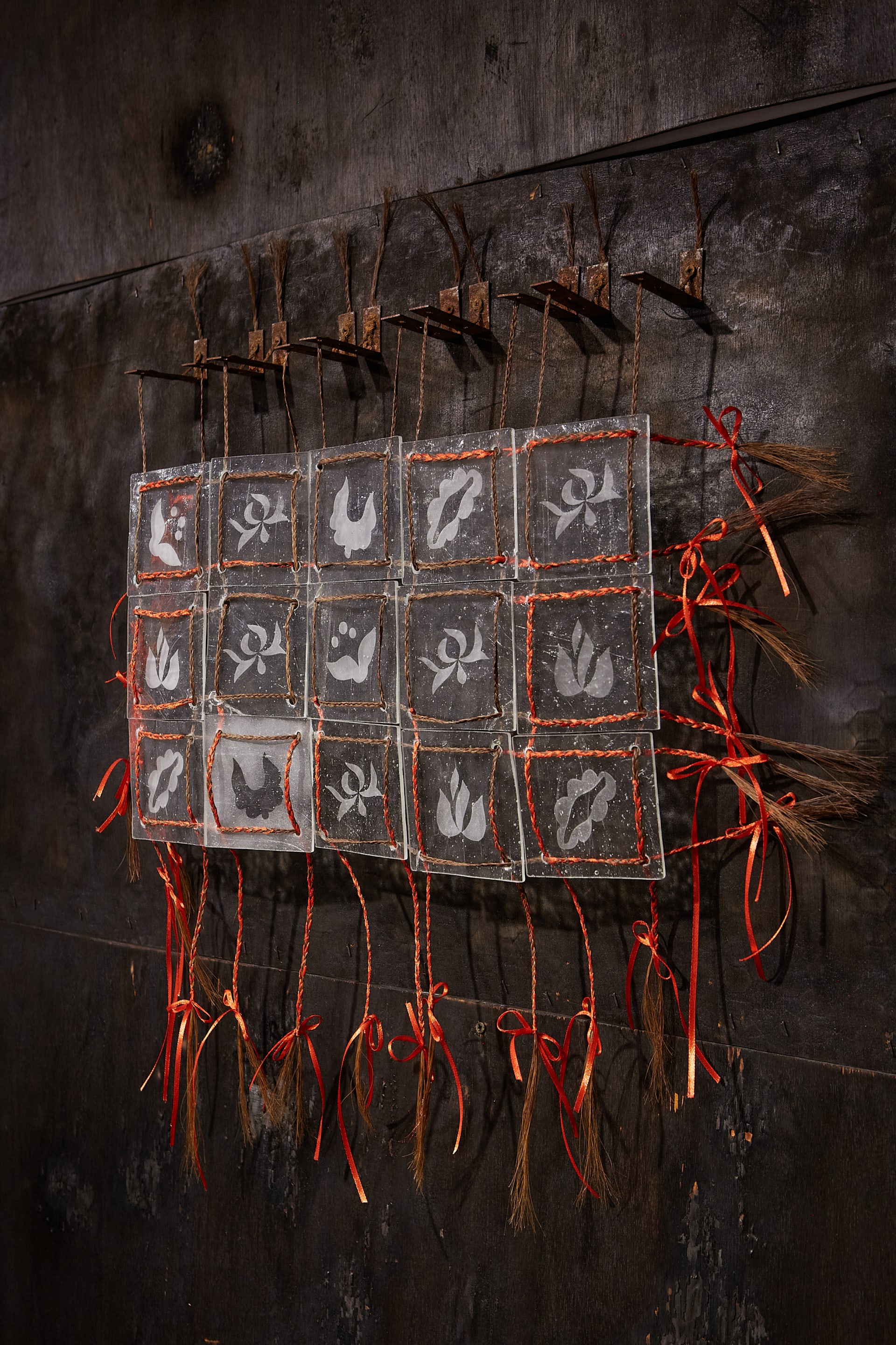 Charred pine wood, etched glass, Transylvanian horse hair, red-satin ribbons, rusted mild steel. Wall mounted installation. 240 x 350 cm
