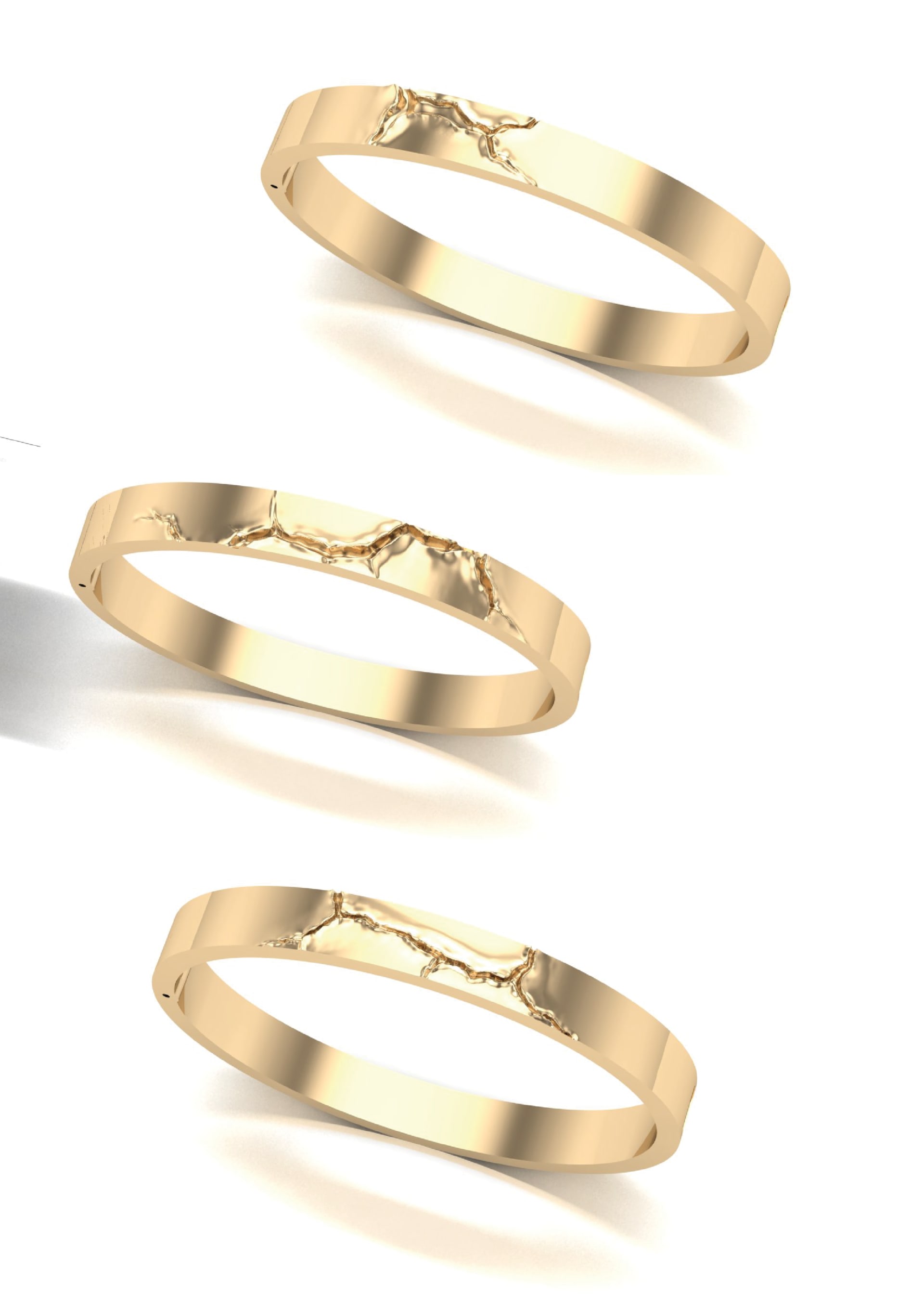 3 gold bangles with cracks in them that look like scarring