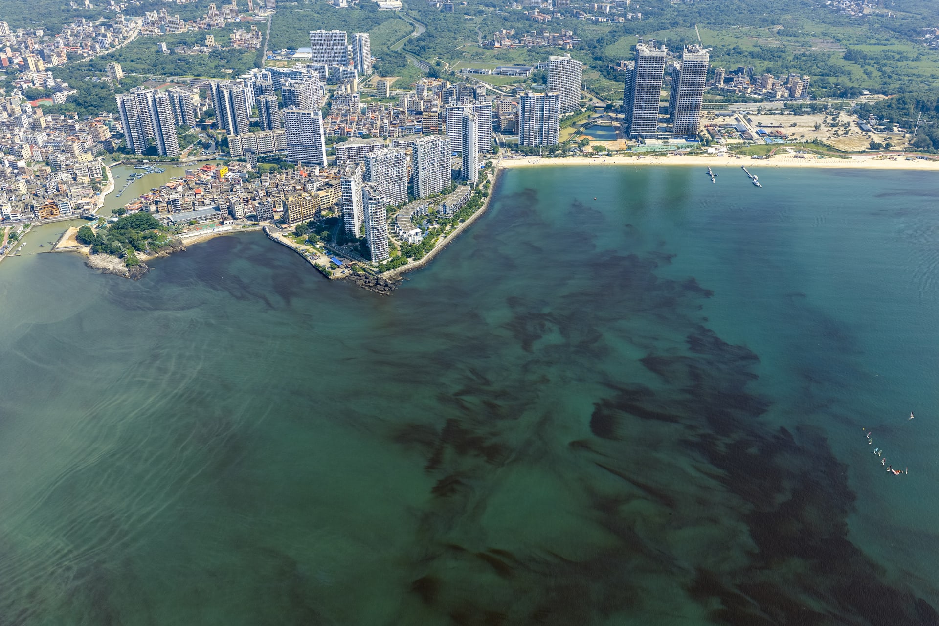 Oblique view of the Daya Bay Golden Coast Tourist Area, with red tide algae blooms under the sea surface.