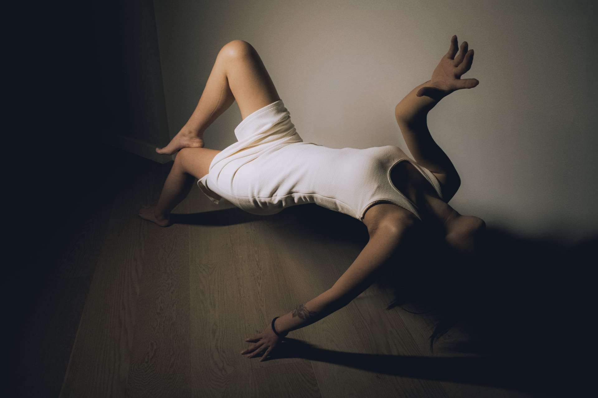 The figure in the photograph appears to be suspended above the floor in a reclining position.