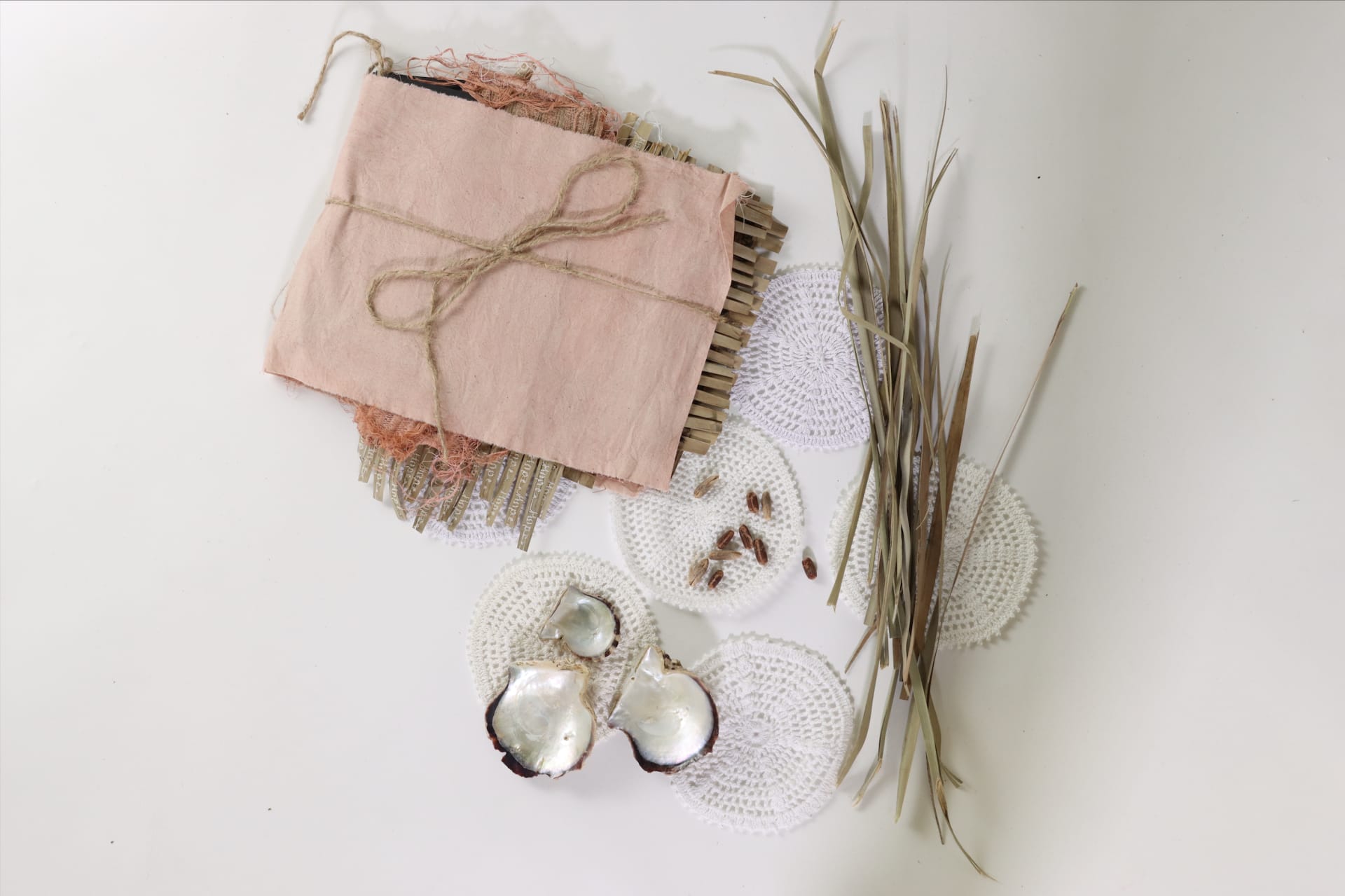 Book and gathered materials - Palm leaves, date pits, oyster shells.