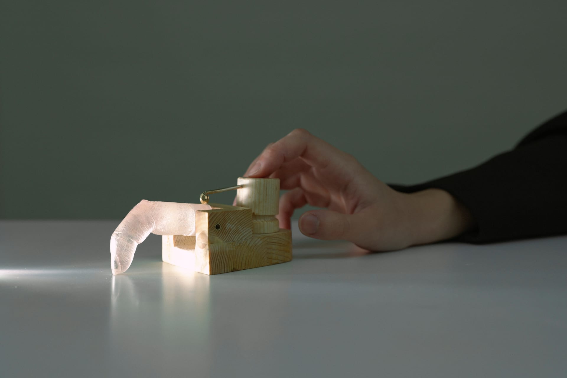 A mechanical object that repeatedly clicks a computer mouse using a spring-driven finger after a single press.