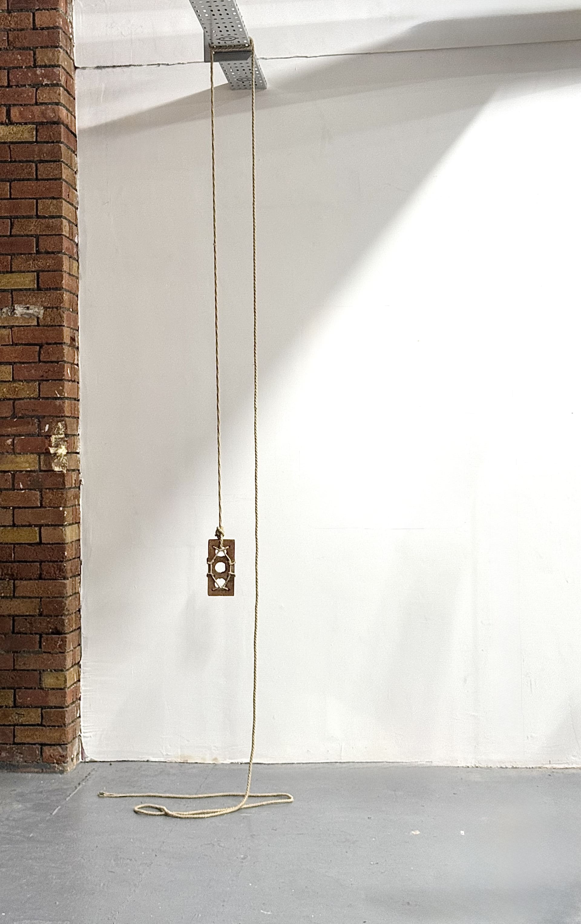 Full length photo of suspended brick showing ceiling to floor installation.