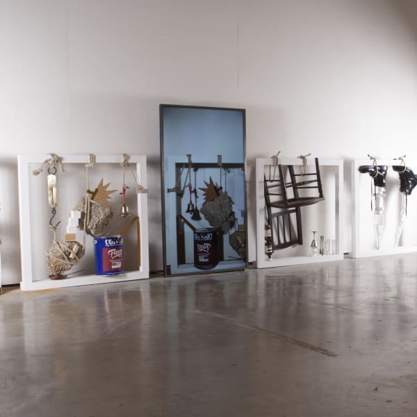 A series of sculptures leant against a wall