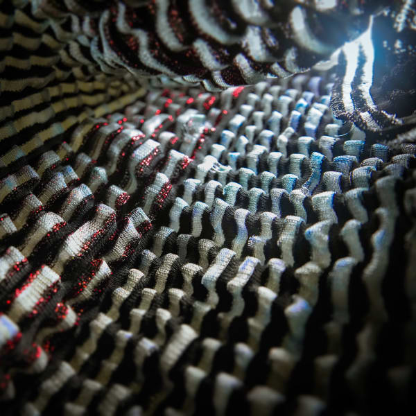 Close-up of knit patterns in grey and bright red.