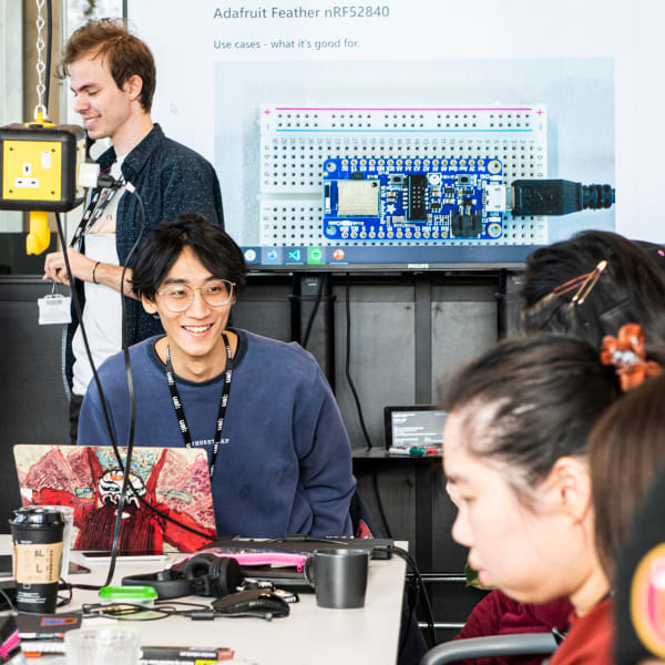 Students working in the studio surrounded by computing equipment