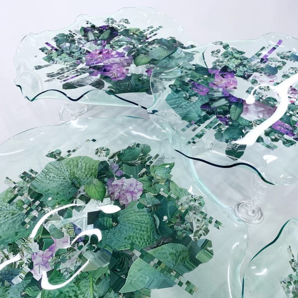 Images of a garden printed onto glass sculptures
