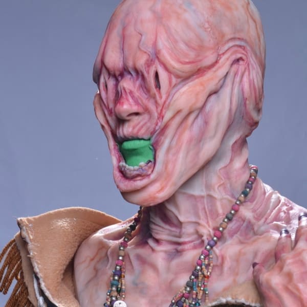Picture of the Shape Shifter, a creature covered in saggy skin and veins, dressed with traditional Inuit clothes
