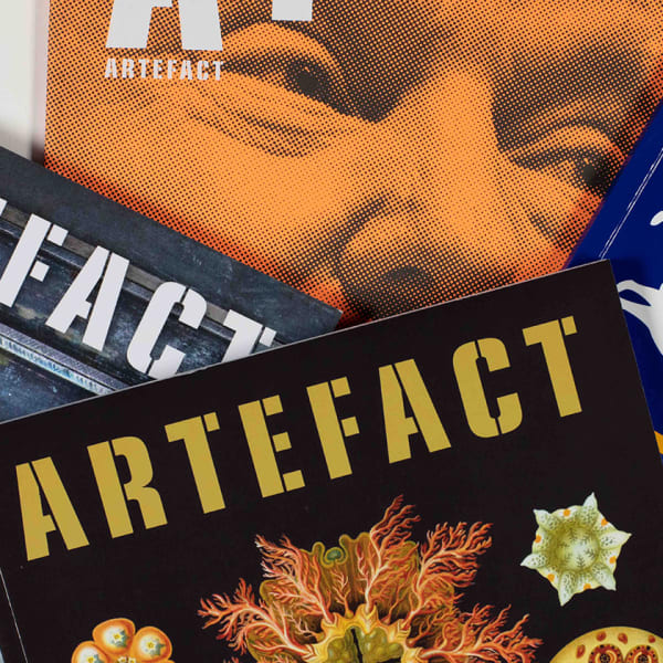 A fan of magazines covers shot against a white background.