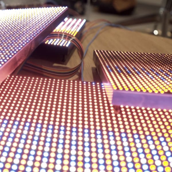 Colourful LED screens stacked on top of each other in a pile