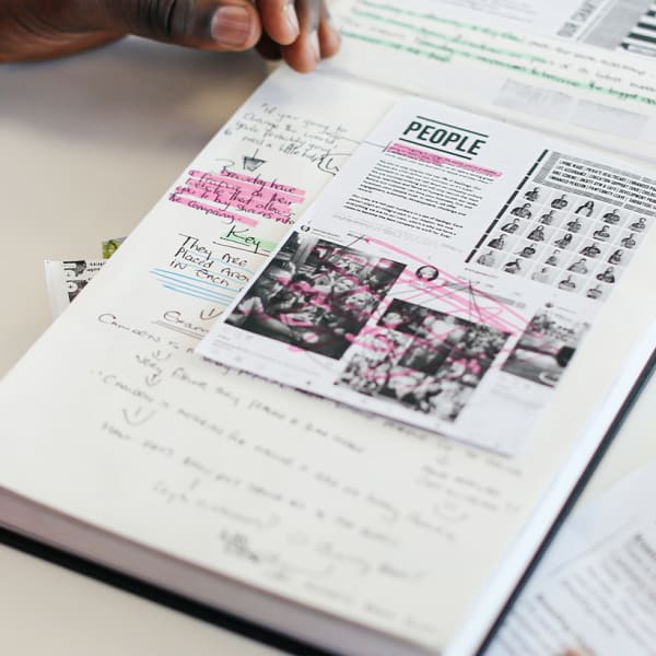 Student working with their notebook with working materials around them