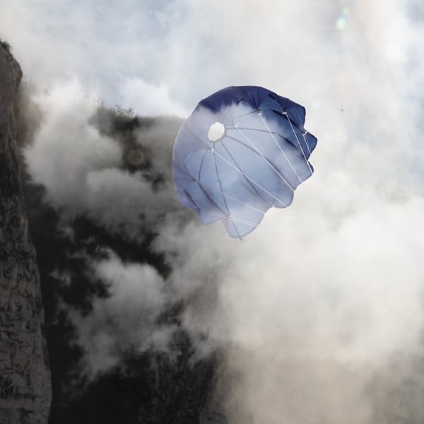 A blue parachute surrounded by clouds of mist