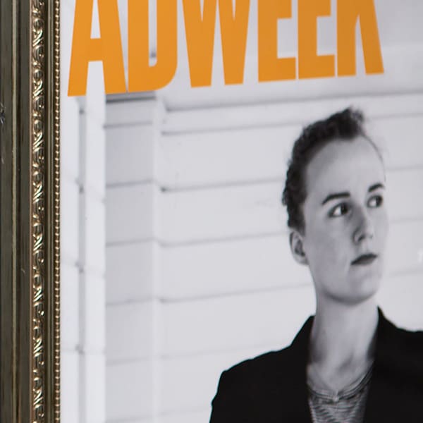 Image of yellow poster in white frame reading 