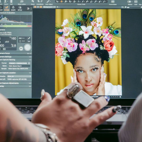 Behind the scenes photograph of students looking at a photoshop mock-up.