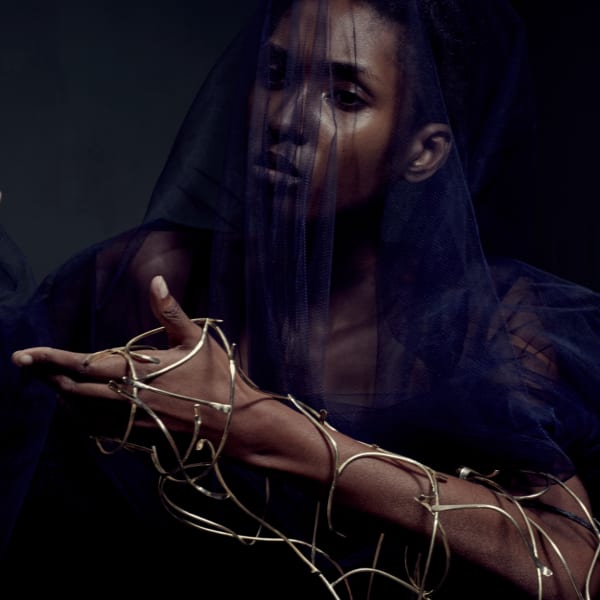 Female model with gold jewellery on her wrist
