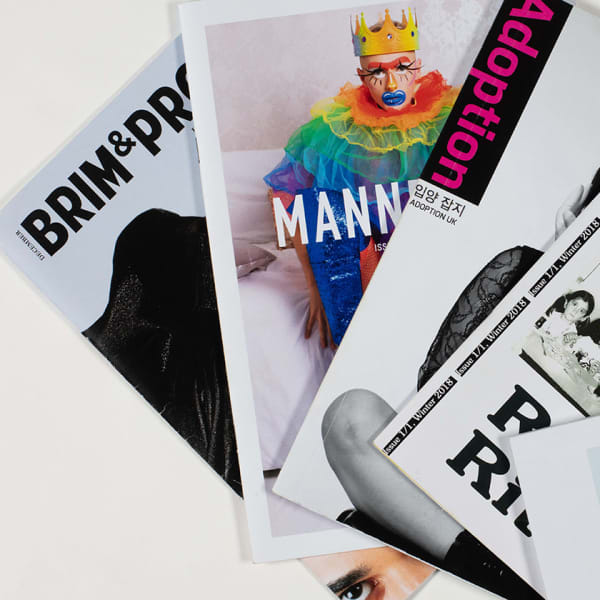 A fan of magazines covers shot against a white background.