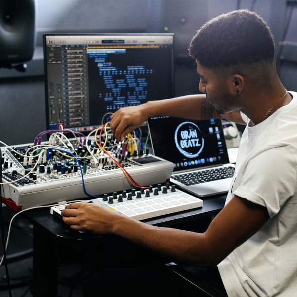 Student sitting at a mixing desk in the College sound studio