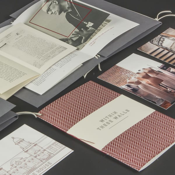 A series of publications laid out on a black table