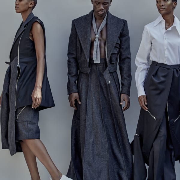 Three models in a variety of navy tailored clothing.