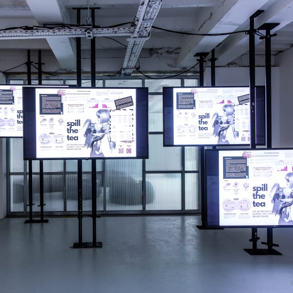 Digital installation showing student work across multiple screens.