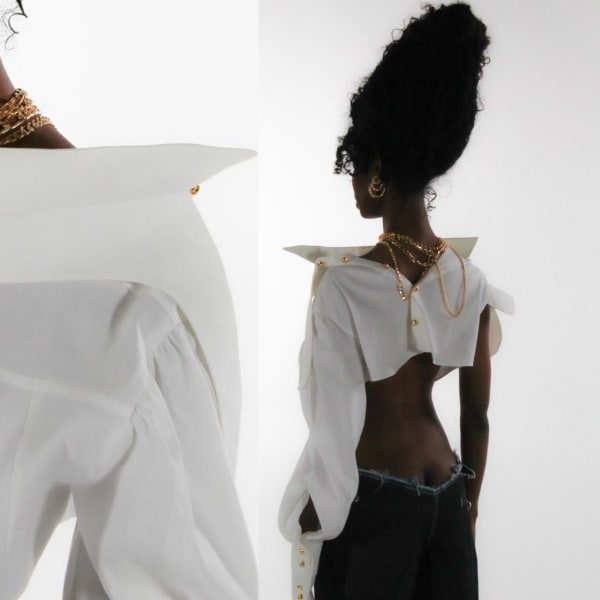 Black female wearing white shirt and gold chain.