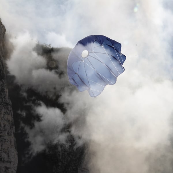 A blue parachute surrounded by clouds of mist