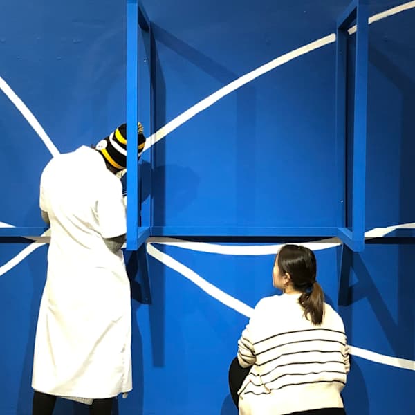 3 students installing an exhibition.