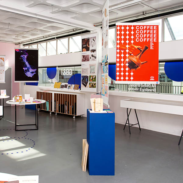 Exhibition shot of graphic branding and identity work inlcuding posters and colourful displays.