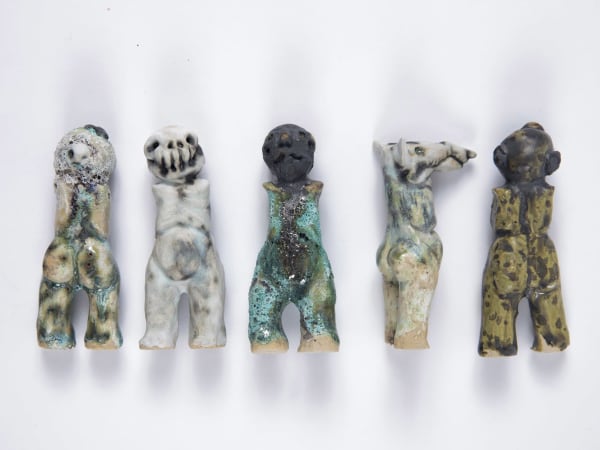 Five distorted human/animal ceramic figures
