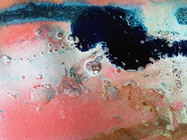 Blue ink running across a pink background