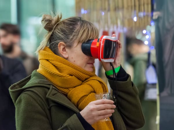 A women looking into an optical instrument 