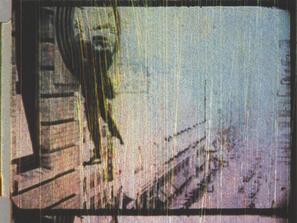 Blurred white and grey image with the outline of a dark clock on the left 