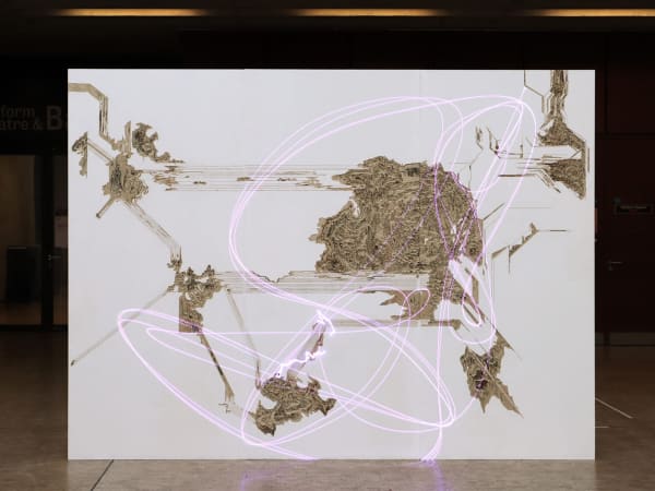 A large white screen or board with brown textured clusters representing a mapping of territories. A soft pink squiggly line is overlaid throughout